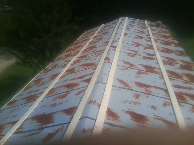 Rusted metal roof panels with new wood purlins before replacement — Storm Damage Roof Repair in Wabash by Roofing Brothers