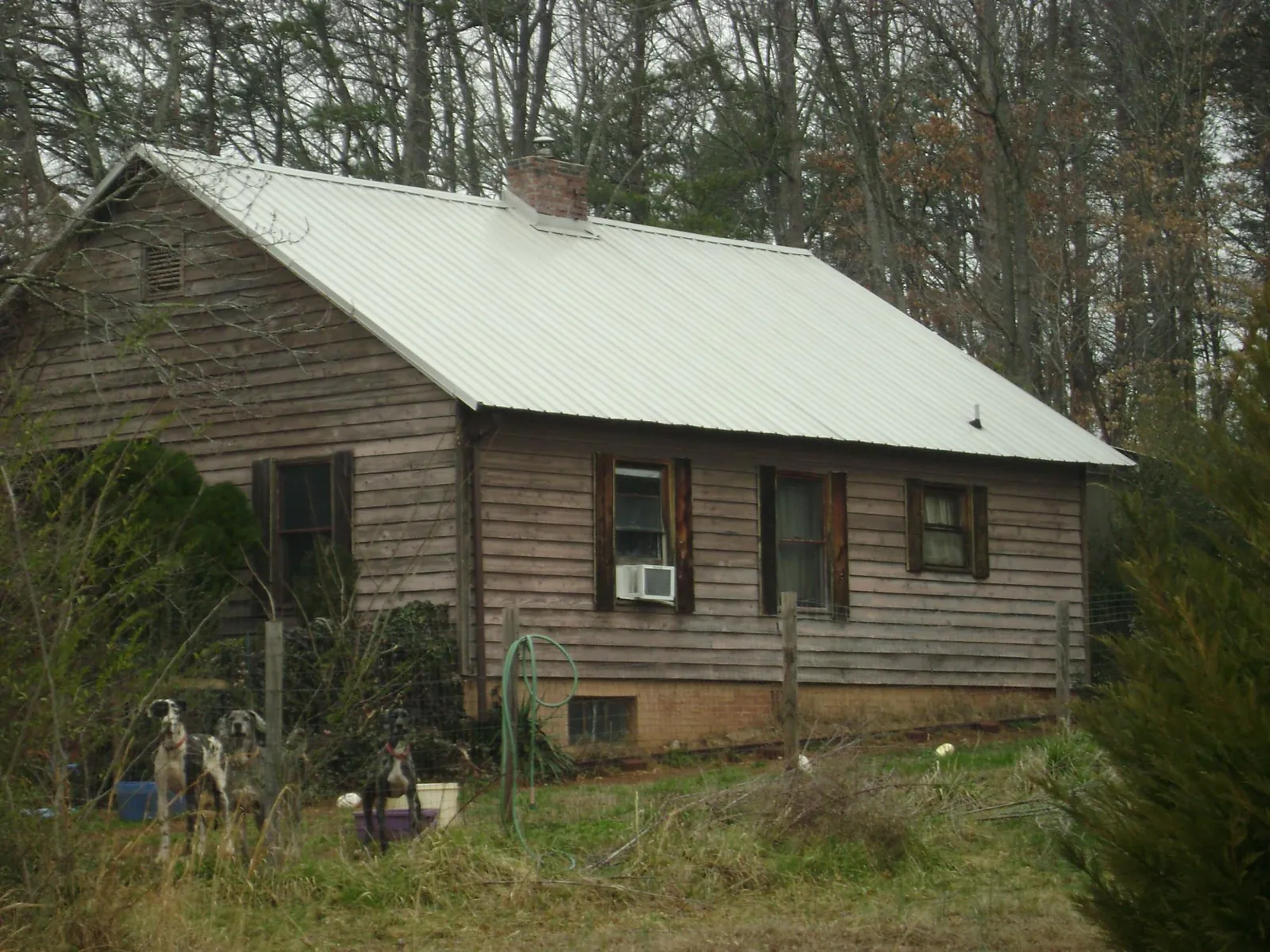 White metal roof on an old wood sided farmhouse, from a Metal Roof Installation job in Wabash
